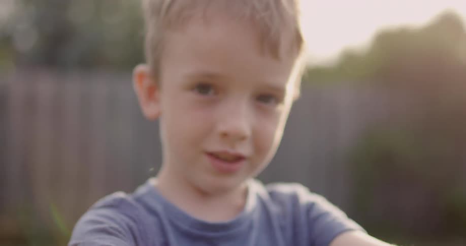 Young boy plays in his yard
