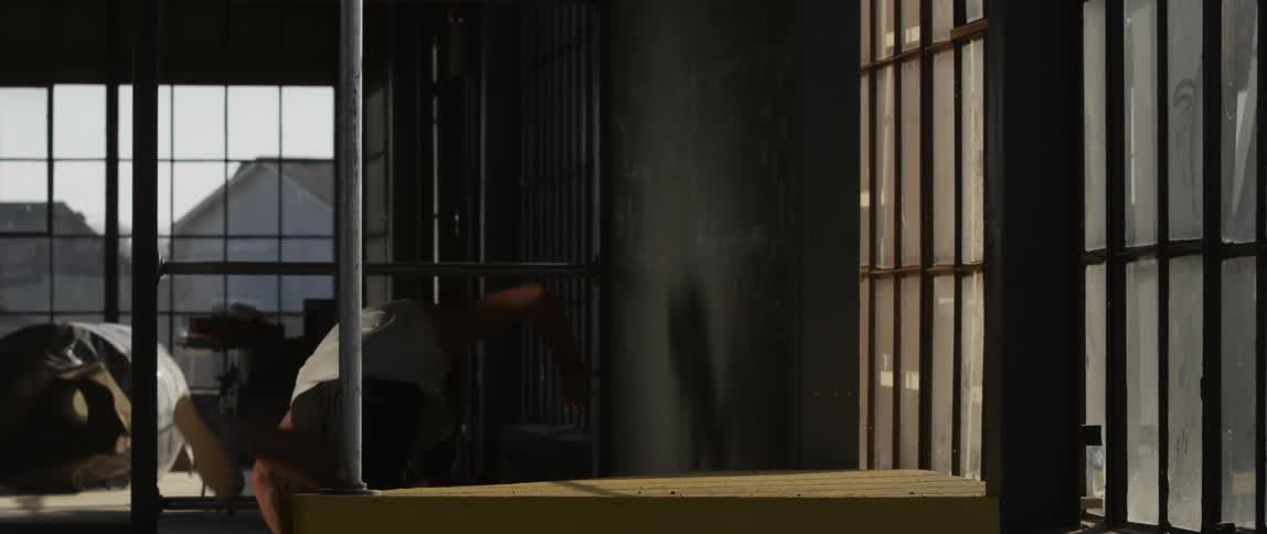 Man jumping and climbing indoors