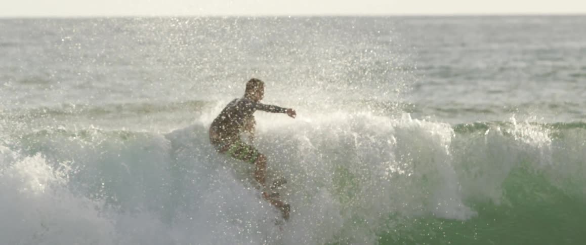 A man surfs in the evening
