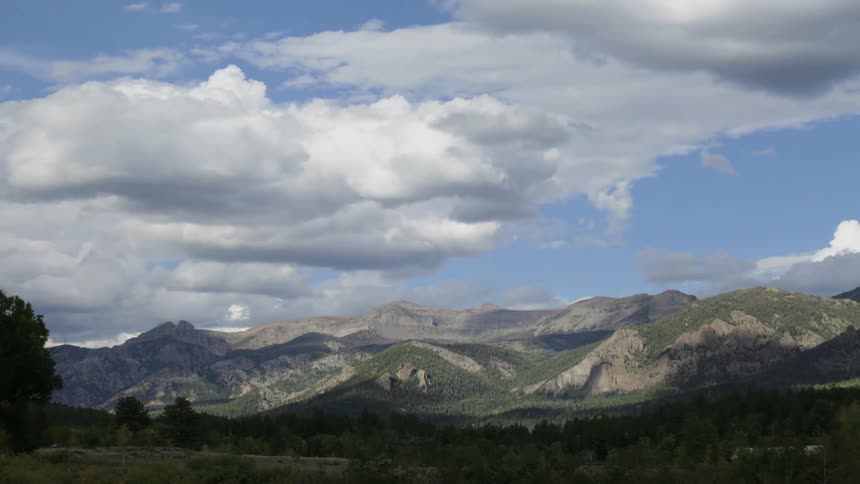 Time lapse of clouds traveling over a mountain range