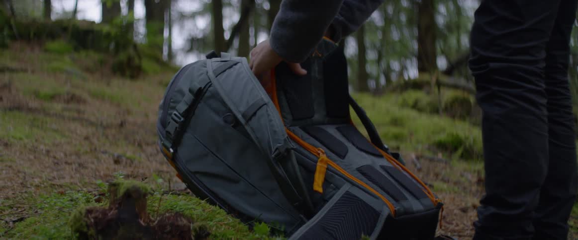 A man opens up a camping backpack