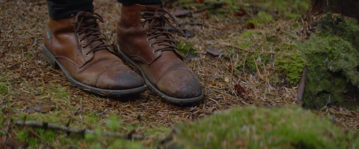 Man wearing boots steps around