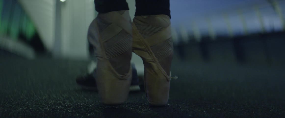 A ballet dancer stretches her feet