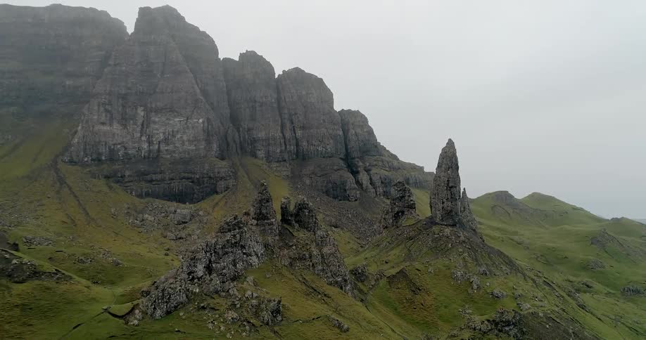 The mountain has grass all along the side