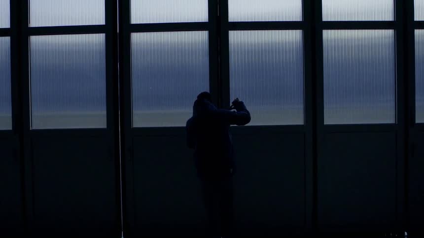 A man closes a folding door