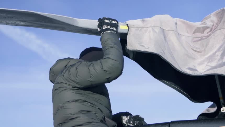 A man pushes a helicopter rotor
