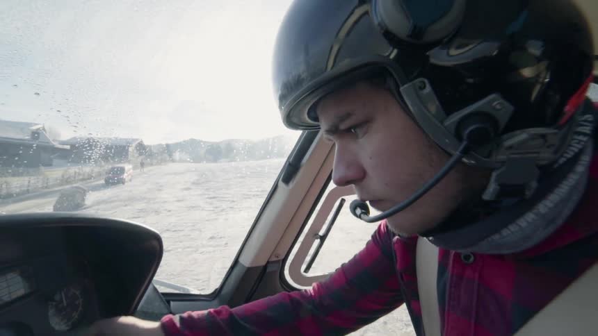 A man lifts his helmet visor