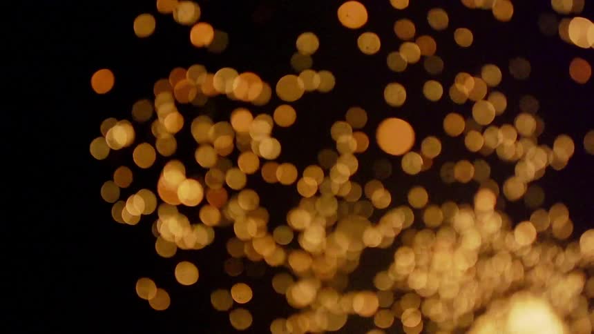 Sparks are flying up against a black screen