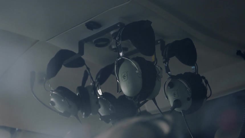 Headphones hang in a helicopter cockpit