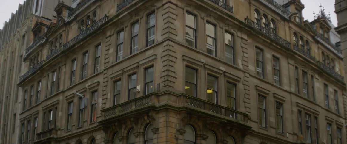 Windows cover a stone city building