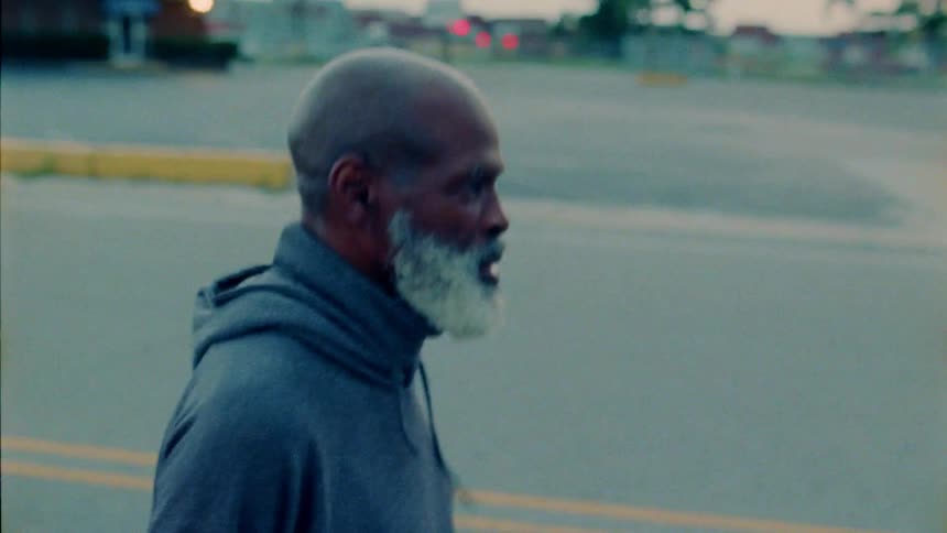 An old man is jogging at dusk