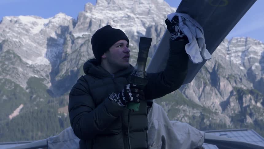A man is heating up the blades of a helicopter