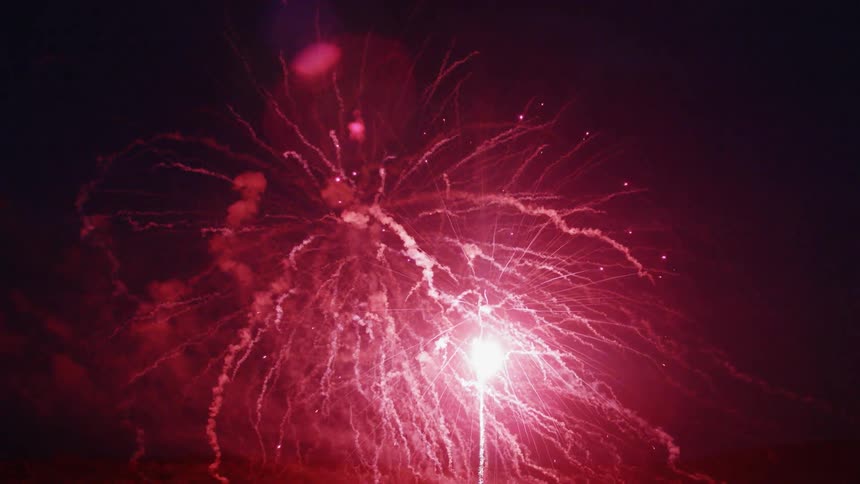 Fireworks launch into the night sky