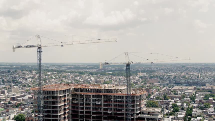 Cranes tower over a building under construction