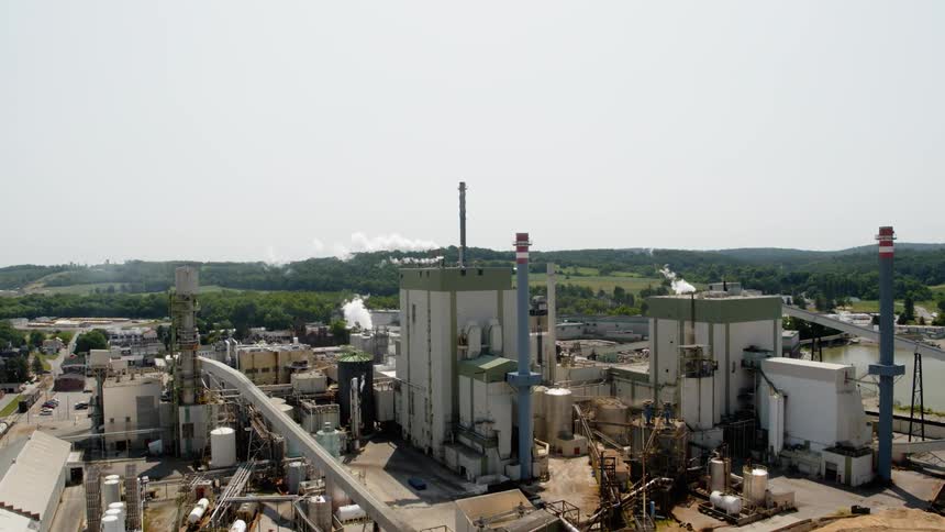 Smoke bellows out of industrial buildings