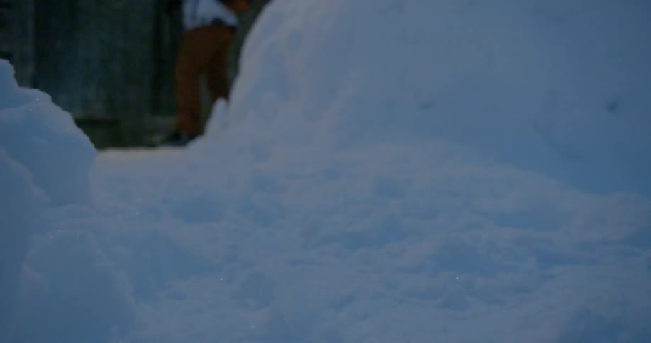 A person walks out of barn on a winter morning