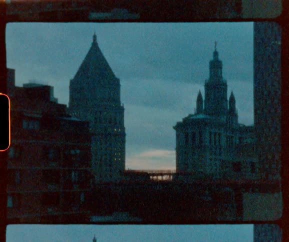 The towers line the cloudy sky of the city