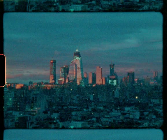 Skyscrapers tower in the distance at dusk