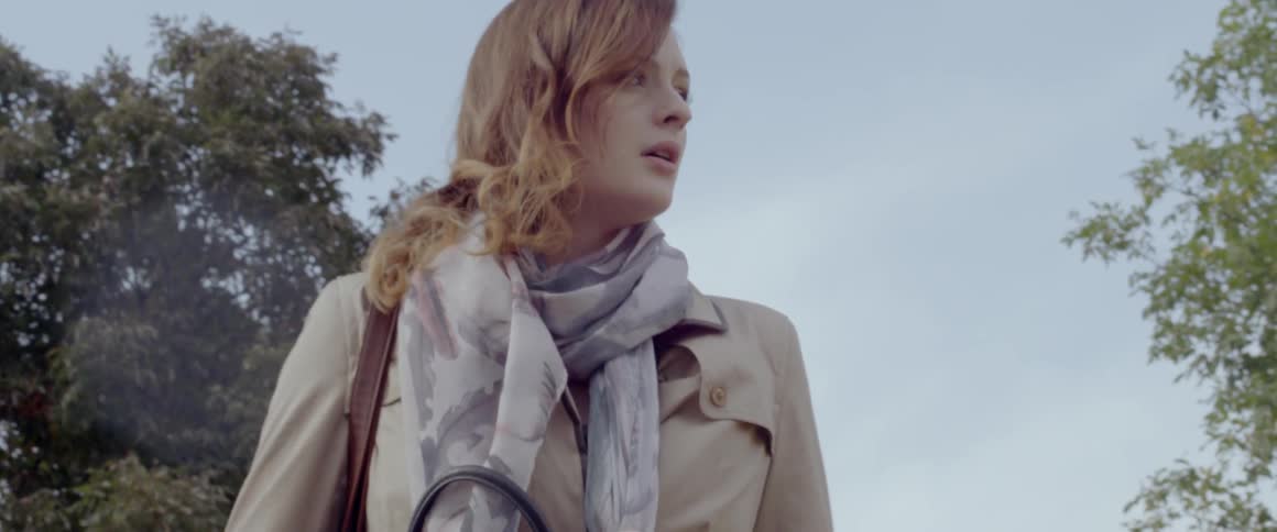 Woman looks worried while standing outside