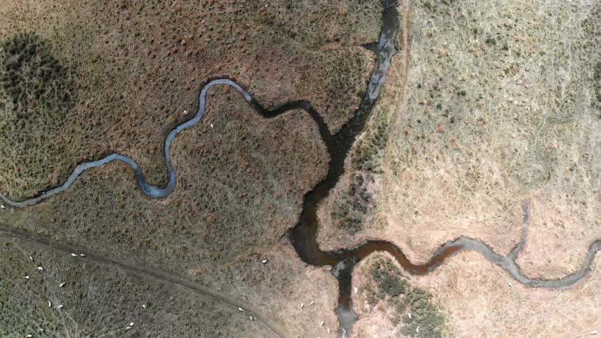 Water flows between land in streams