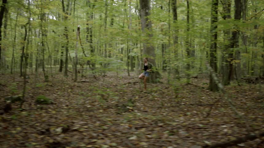 Woman runs through the woods