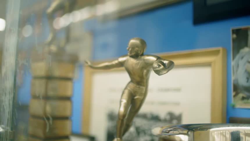 A close up of a high school football trophy