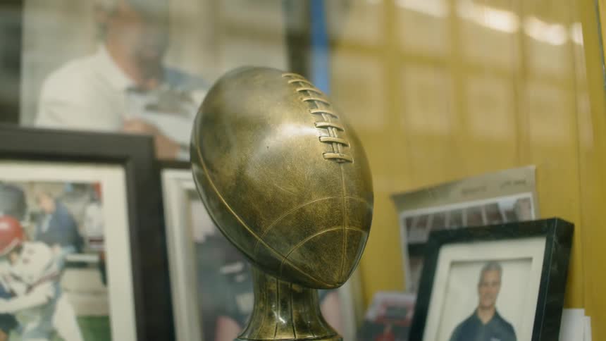 A football trophy inside a case