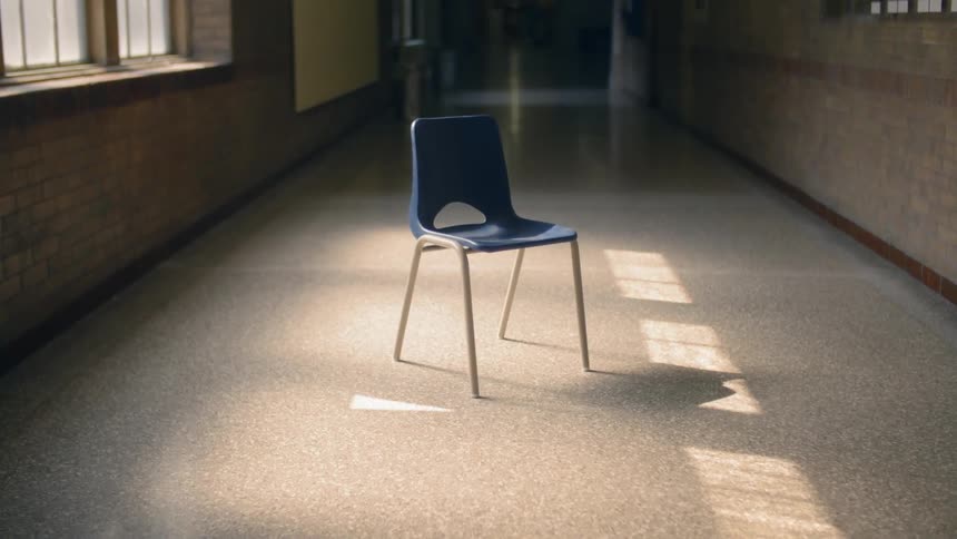 A chair sitting in the middle of an empty hallway