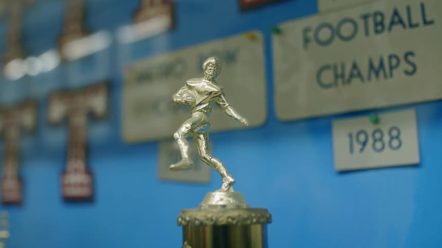 A close up view of a high school football trophy
