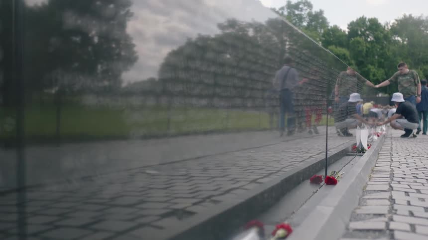 rack focus of names on vietnam veterans memorial