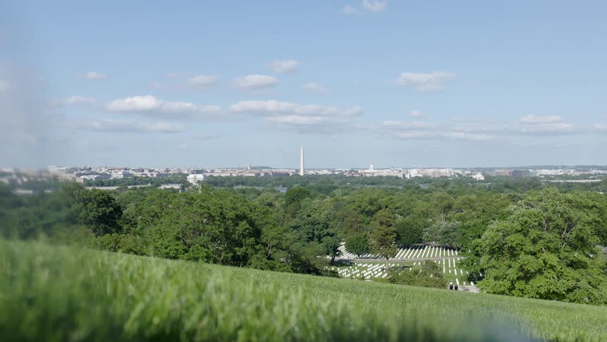 A cemetery sits at the bottom of a hill