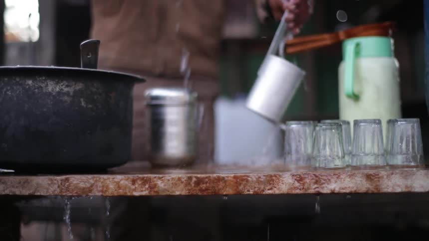 Man cleaning some glasses on a counter