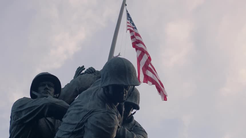 A plane flies over a war monument