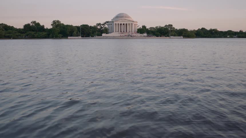 The jefferson memorial is shown as the sun sets