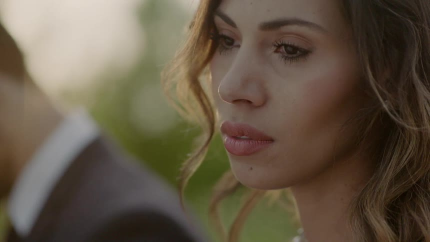 A woman is standing next to a man with a sad look on her face