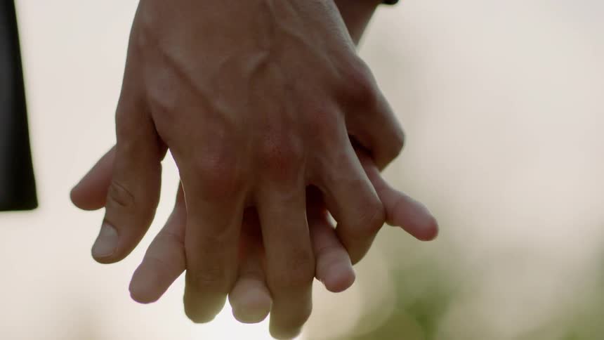 Two people decide to hold hands