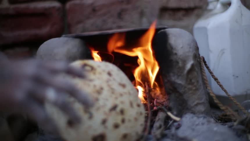 A person feeding a fire