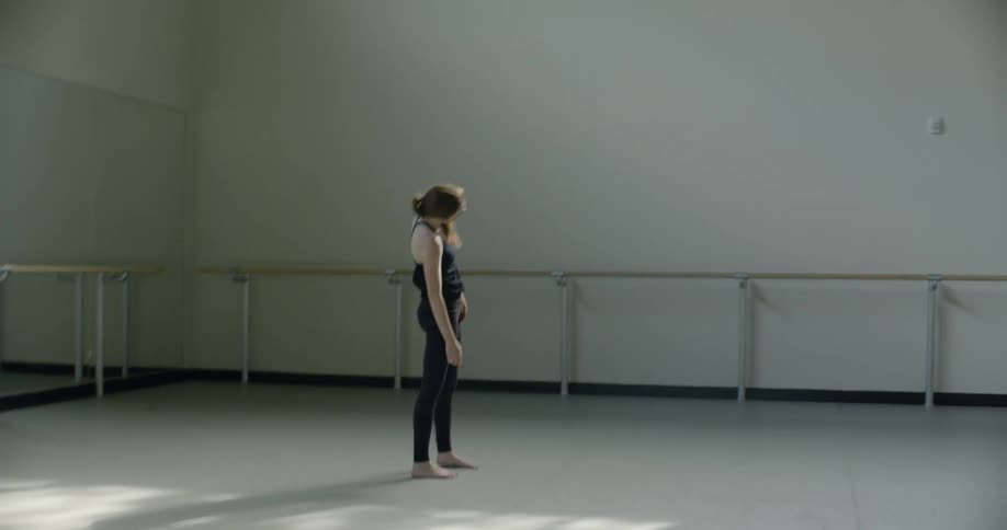 A female dancer practices in a dance studio