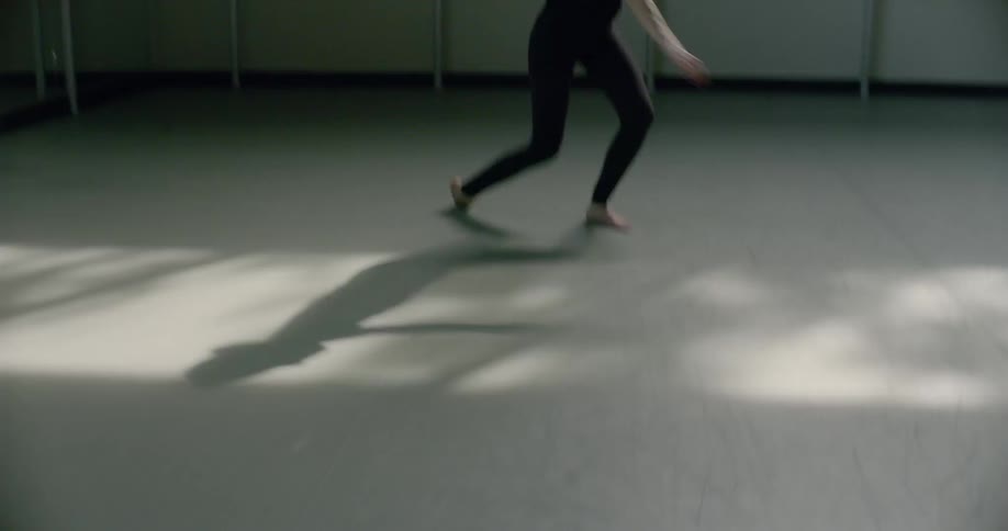 A female dancer practices in a dance studio