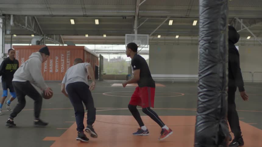 Man shooting a basketball in a game
