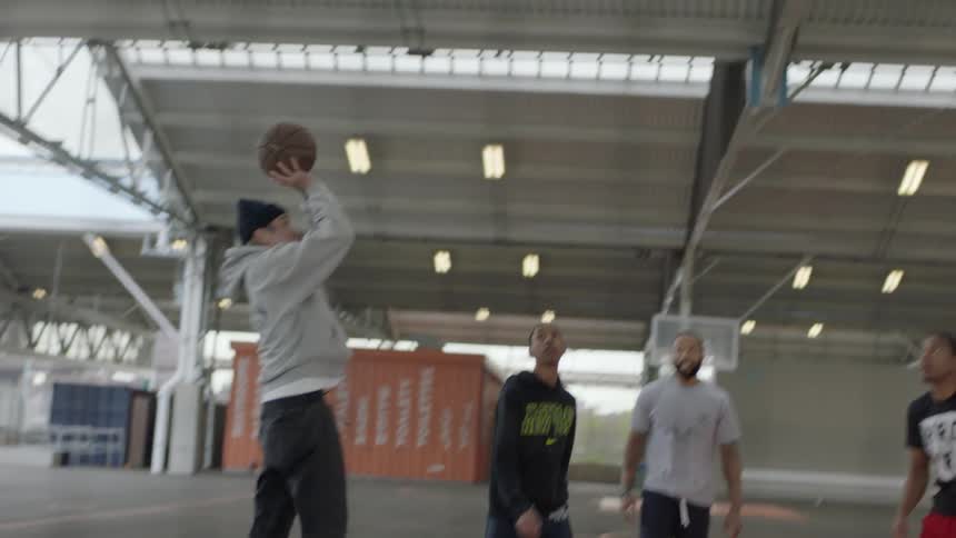 Friends playing basketball on a court