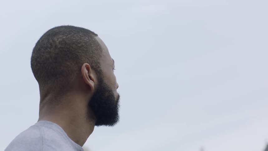 Man with beard looking out to a skyline