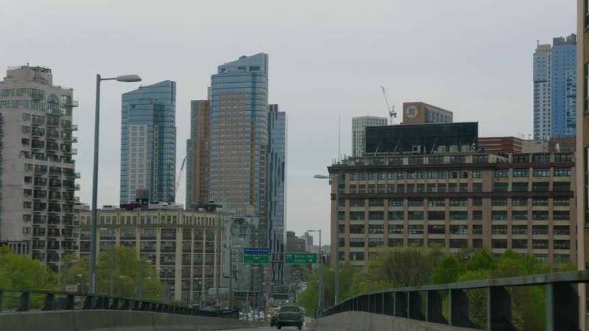 Driving through city with large buildings