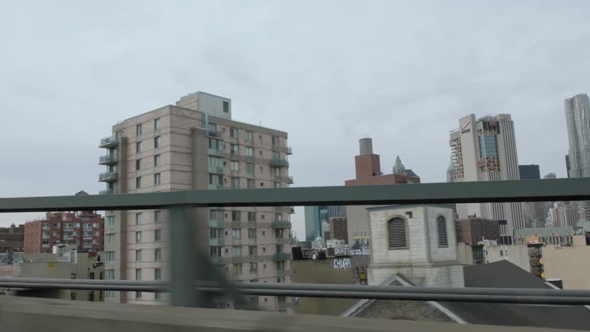 Driving across road in the middle of city and buildings