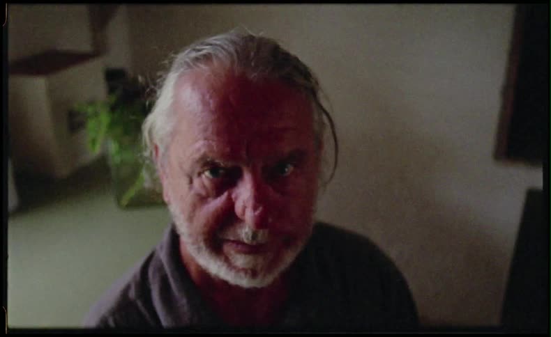 Elderly man in a room looking up