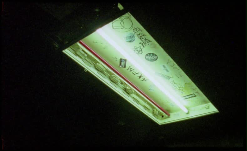 Fluorescent light on ceiling with graffiti