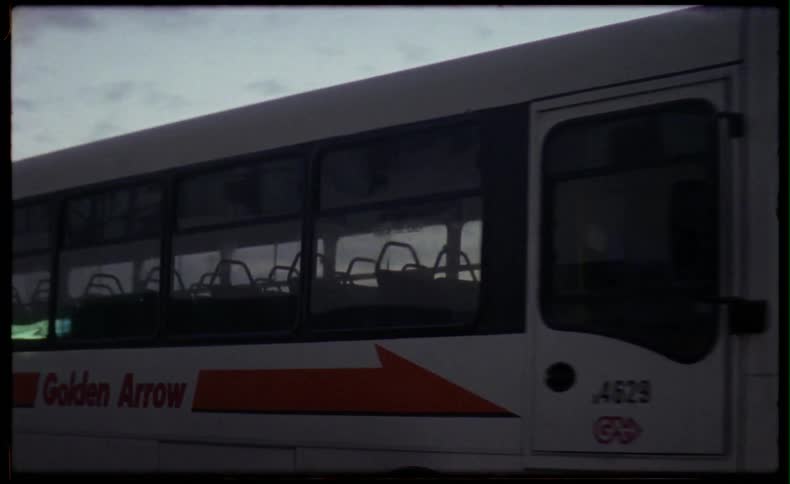 A city bus is driving down the street
