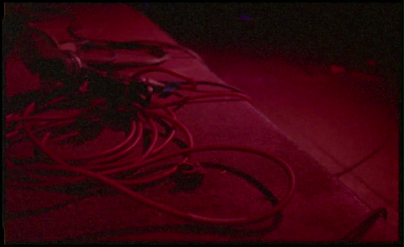 Cables lit up red and wrapped up on the ground 