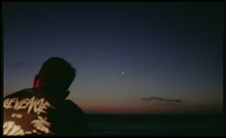 Man looking at the sunset after smoking a cigarette