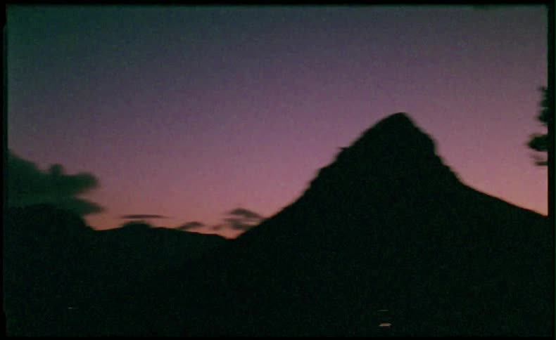 Trees and mountain at dusk